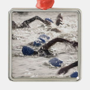 Triathletes competing in swim leg of triathlon. metal ornament