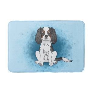 Tricolor Cavalier King Charles Spaniel Dog On Blue Bath Mat