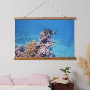 Triggerfish rests on a coral block at coral reef hanging tapestry