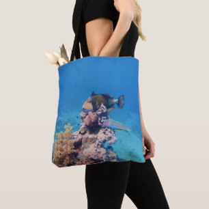 Triggerfish rests on a coral block at coral reef tote bag