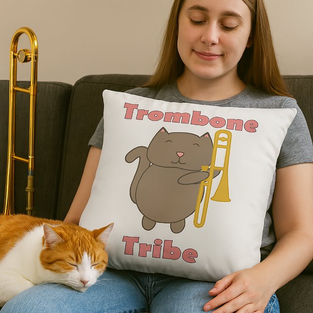 Trombone Tribe Cute Brown Cat Pink Letters Throw Pillow (A throw pillow features a cute cat holding a trombone and the text trombone tribe in pink letters.)