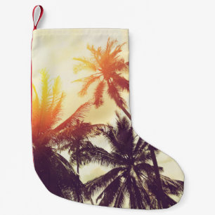 Tropical beach background with palm trees silhouet small christmas stocking