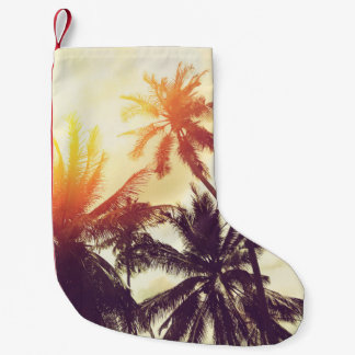 Tropical beach background with palm trees silhouet small christmas stocking