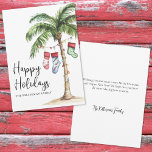 Tropical Beach Christmas Happy Holidays Holiday Card<br><div class="desc">Get into the holiday spirit with this festive watercolor Christmas card featuring a large palm tree wrapped in colourful Christmas lights. Three holiday stockings hang playfully from the fronds, while soft beach sand rests at the base—bringing a warm and tropical twist to your holiday greetings. The front features "Mele Kalikimaka"...</div>