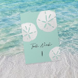 Tropical Beach Sea Glass & White Sand Dollars  Table Number<br><div class="desc">This modern and elegant tropical beach sea glass table card features three white sand dollars on a sea green background and elegant calligraphy script. This card is perfect for the couple having a tropical wedding, beach wedding, or other destination wedding in Hawaii, Florida, California, Mexico, the Caribbean, or any other...</div>