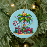 Tropical Christmas Palm Tree Ceramic Ornament<br><div class="desc">An ornament with a seasonal holiday image. A tropical palm tree decorated in festive lights with a star on top. A giant red and white candy cane sticking out of the sand. Christmas presents under the tree. Whimsical and fun.</div>