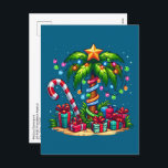 Tropical Christmas Palm Tree Holiday Postcard<br><div class="desc">Christmas postcard with a seasonal holiday image. A tropical palm tree decorated in festive lights with a star on top. A giant red and white candy cane sticking out of the sand. Christmas presents under the tree. Whimsical and fun.</div>