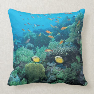 Tropical fish swimming over reef throw pillow