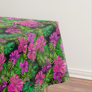 Tropical flowers and plants on black  tablecloth