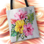 Tropical Flowers Gray Wood Personalized AOP Tote Bag<br><div class="desc">Personalized tote bag with big flowers design. All over print with pink and yellow hibiscus flowers. More little flowers and leaves make up this pretty design which has a background of light gray wood grain. Include a name down the side of the front in elegant script font. This tote is...</div>