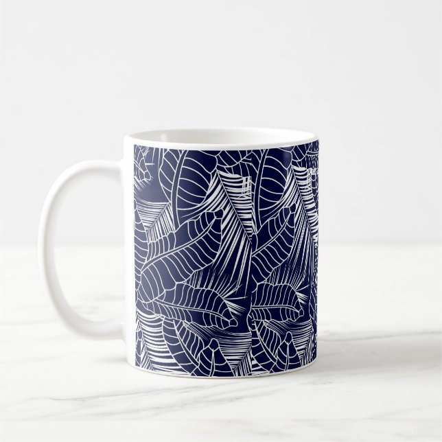 tropical leaf pattern on the navy blue background coffee mug (Left)