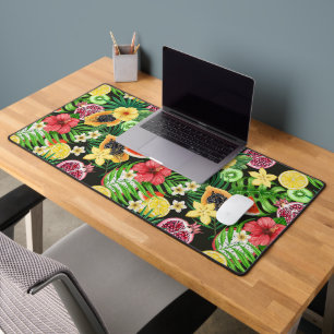 Tropical mix-fruit, flowers and leaves on black desk mat