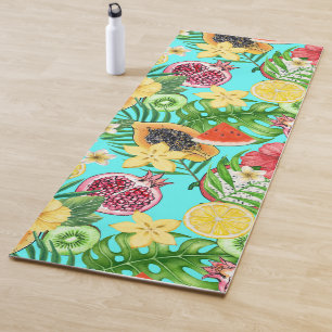Tropical mix-fruit, flowers and leaves on blue yoga mat