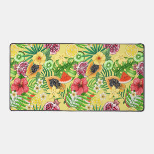 Tropical mix-fruit, flowers and leaves on yellow desk mat