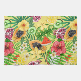 Tropical mix-fruit, flowers and leaves on yellow kitchen towel
