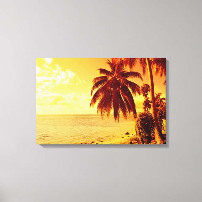 Tropical palm trees at a beach at sunset canvas print (Front)