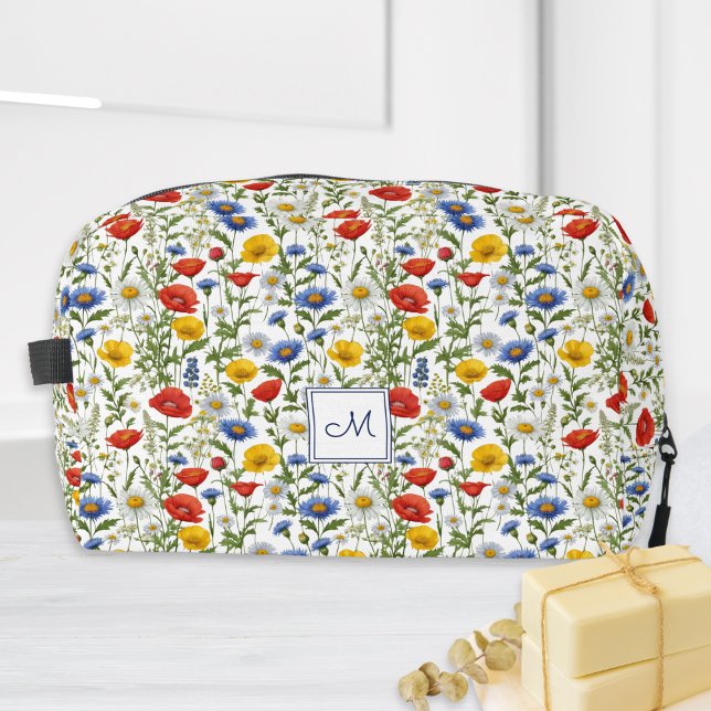 Trousse De Toilette Fleurs Sauvages Colorées Monogramme Floral Botaniq (A pretty monogrammed toiletry bag, adorned with a bright, colorful pattern of wildflowers)