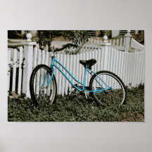 Turquoise Bicycle Leaning on a White Picket Fence