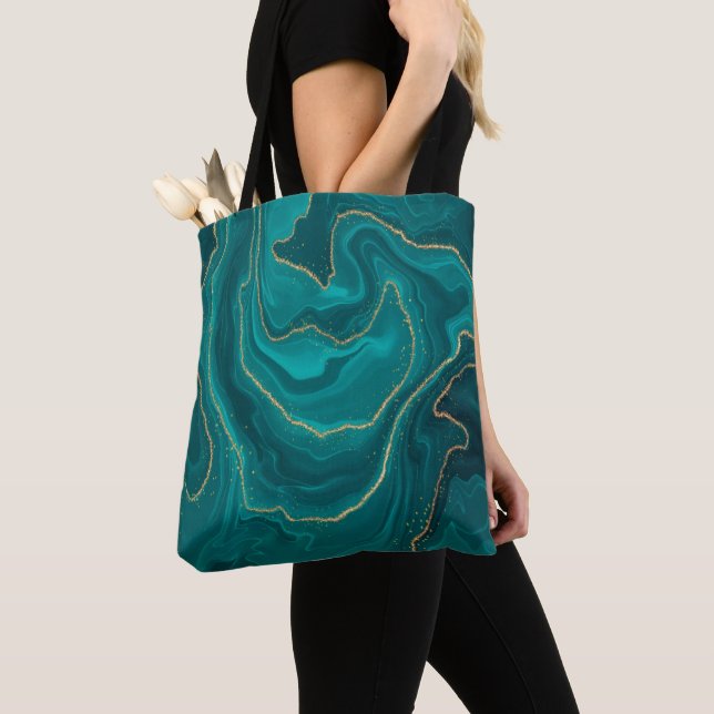 Turquoise liquid marble background with gold tote bag (Close Up)