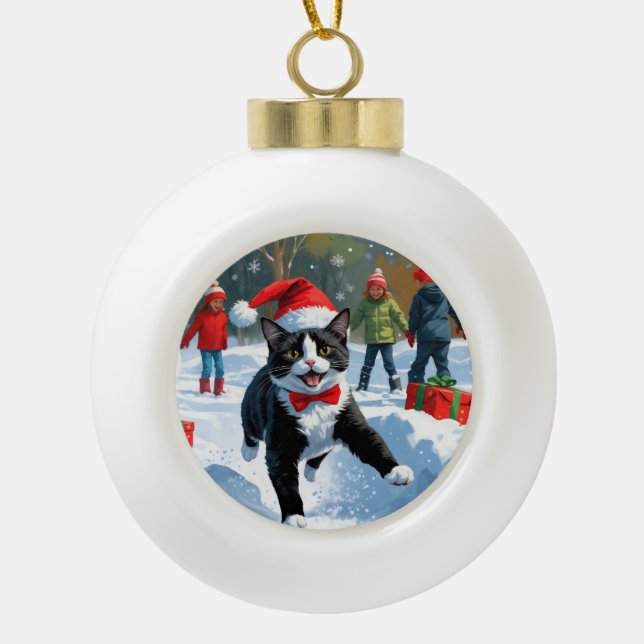 Tuxedo Cat Running in Snow with Christmas Hat Ceramic Ball Christmas Ornament (Front)