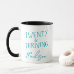 TWENTY & THRIVING 20th Birthday Funny Personalized Mug<br><div class="desc">Celebrate turning twenty in style with this vibrant TWENTY & THRIVING birthday mug featuring bold turquoise lettering. This custom name coffee mug makes a fun and thoughtful gift for anyone embracing their twenties with confidence and energy. A perfect keepsake for morning coffee, dorm life, or birthday brunch. Also available in...</div>
