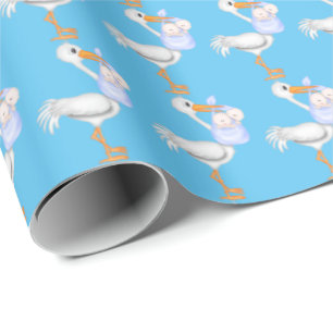 Twin baby boys with stork wrapping paper