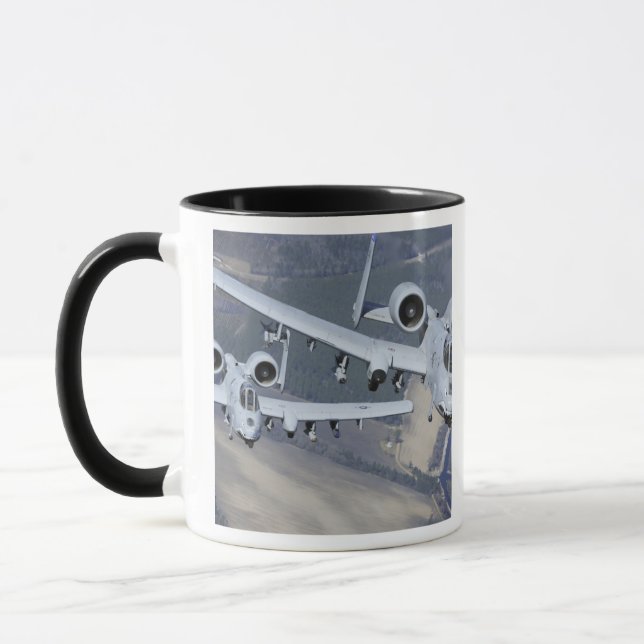 Two A-10C Thunderbolt II aircraft fly in format Mug (Left)