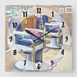 Two Barber Chairs With Pink Striped Barber Capes Square Wall Clock
