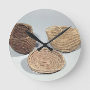 Two baskets and a cover (woven palm fronds) round clock