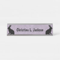 Two Black Sitting Rabbits in Silhouette on Purple