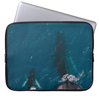TWO BLACK WHALES SWIMMING IN BODY OF WATER LAPTOP SLEEVE