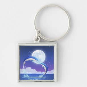 Two bottle-nosed dolphins jumping out of water keychain