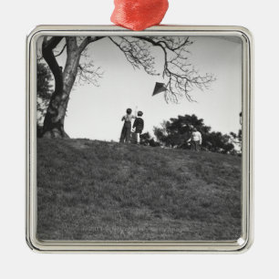 Two boys flying kite on hill B&W Metal Ornament