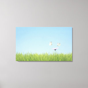 Two butterflies hovering over flower canvas print