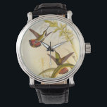 Two Colourful Hummingbirds Aiming for Same Flower Watch<br><div class="desc">Artist John Gould was passionate about birds. In this coloured drawing,  the two hummingbirds and the flower are represented beautifully. The details in this colourful fine art will delight any art lover.</div>