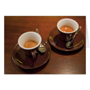 two cups of freshly brewed espresso coffee on a