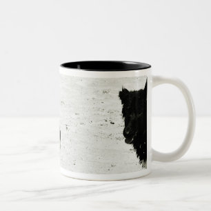 Two dogs playing on a beach. Two-Tone coffee mug