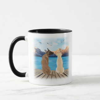 Two dogs sitting on a dock looking at the water mug