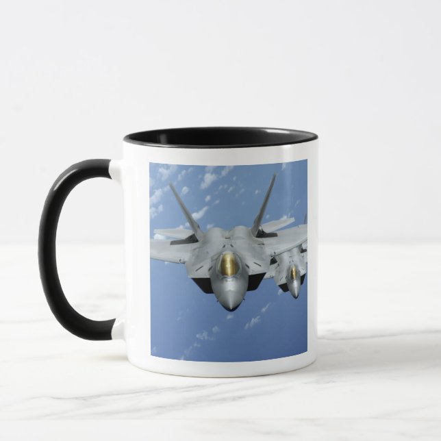 Two F-22 Raptors fly over the Pacific Ocean 2 Mug (Left)