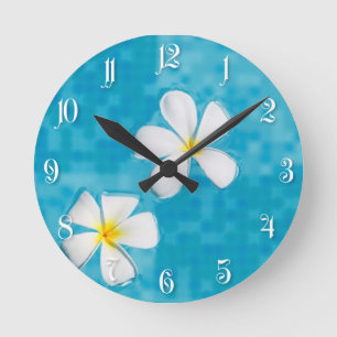 Two frangipani flowers in a blue water round clock