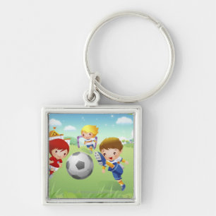 Two girls and a boy playing soccer keychain