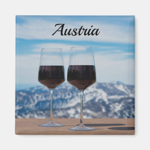 Two glasses of red wine against mountains magnet