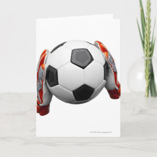 Two goal keepers gloves holding a football card