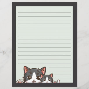 Two grey kittens on lined with grey paper