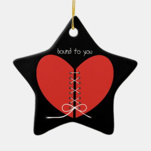 Two halves of a heart tied with a ribbon ornament