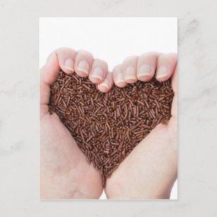 Two hands holding chocolate sprinkles postcard