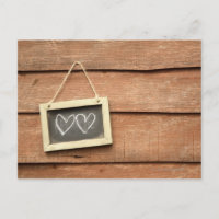 Two hearts drawn on small blackboard on garden