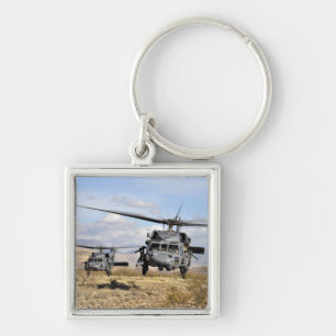 Two HH-60 Pavehawk helicopters preparing to lan Keychain