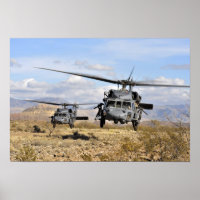 Two HH-60 Pavehawk helicopters preparing to lan
