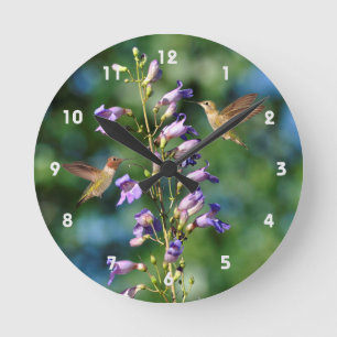 Two Hummingbirds In Flight With Flowers Wall Clock